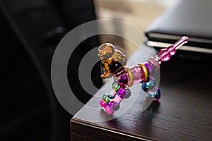 Closeup shot of twisty pet toy bracelet on a wooden table