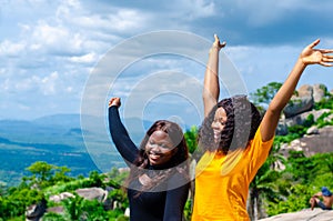 Closeup shot of two African young females taking selfies outdoors under sunlight