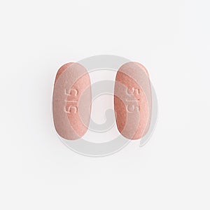 Closeup shot of two oval medical pills isolated on a white background