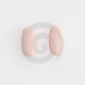 Closeup shot of two oval medical pills isolated on a white background