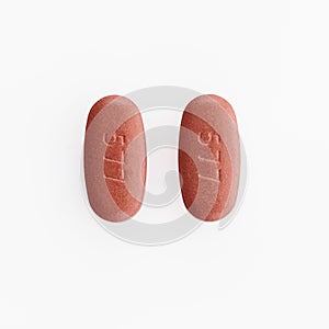 Closeup shot of two oval medical pills isolated on a white background