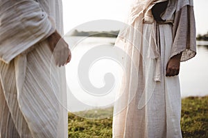 Closeup shot of two people wearing a biblical robe with a blurred background