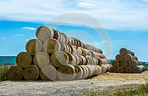 Closeup shot of two piles of hays in the field at daytime