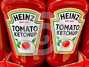 Closeup shot of two plastic bottles of Heinz tomato ketchup in a cardboard tray