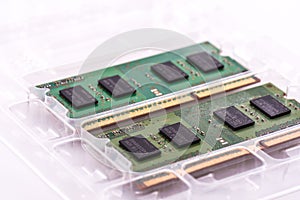 Closeup shot of two SODIMM memory modules in protective packaging on a white background