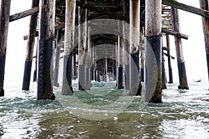 Closeup shot under pier with calm blue sea