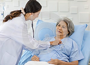 Closeup shot of unrecognizable unknown doctor in white lab coat with stethoscope hand holding comforting supporting old senior