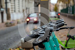 Closeup shot of the upper part of electric scooters parked outside on a street