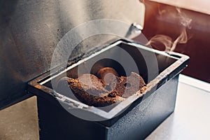 Used hot coffee grounds from espresso machine maker