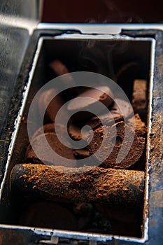 Closeup shot of used hot coffee grounds from espresso machine maker.