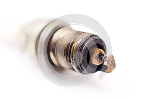 closeup shot of  used spark plug on white background