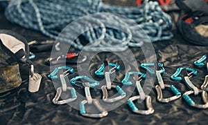 Closeup shot of a variety of carabiner hooks, rope, and other safety equipment used for rock or mountain climbing