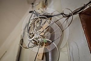 Closeup shot of a variety of electrical cords attached to the wall