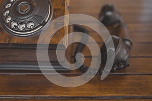 Closeup shot of a vintage wooden telephone on a wooden surface