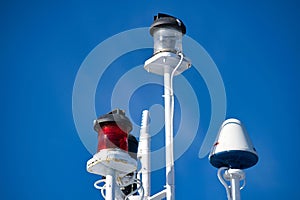 Closeup shot of warning and alerting lights on top of a boat against a clear blue sky