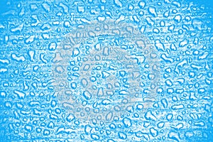 Closeup shot of waterdrops on a blue surface- background