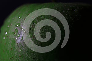 Closeup shot of waterdrops on a green apple