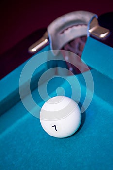 Closeup shot of white ball going in pocket