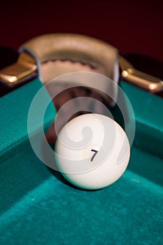 Closeup shot of white ball going in pocket