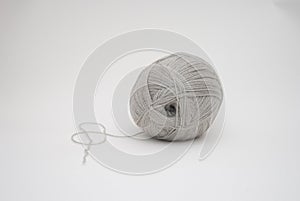 Closeup shot of a white ball of string on white background