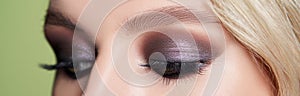 Closeup shot of woman eye with evening makeup. Long eyelashes. Smokey Eyes