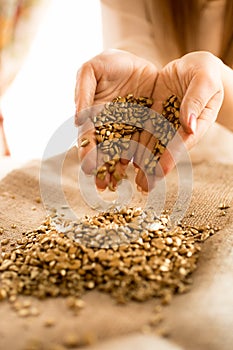 Closeup shot of woman holding pieces of gold in hand