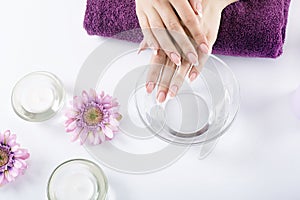 Closeup shot of a woman in a nail salon receiving a manicure by