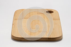 Closeup shot of a wooden chopping board isolated on a white background