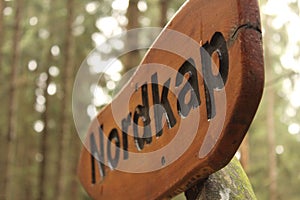 Closeup shot of a wooden signage with Nordkap text in the woods in Germany