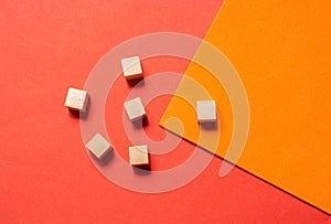 Closeup shot of wooden squares on a geometric orange surfa