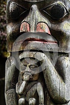 Closeup shot of a wooden Tlingit totem pole photo