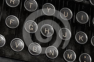 Closeup shot of the writing keys of an antique black typewriter