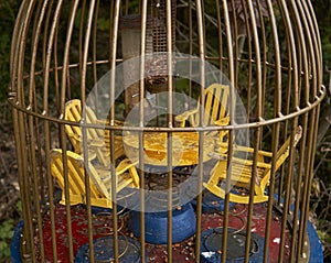 Closeup shot of a yellow carousel in a parrot cage