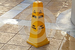 Closeup shot of a yellow caution wet floor sign