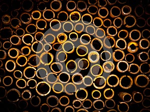 Closeup shot of yellow-colored steel casing pipes creating the illusion of a beehive