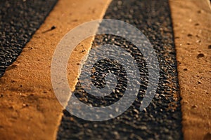 Closeup shot of yellow marking lines on an asphalt road