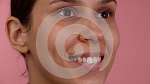 Closeup shot of young beautiful caucasian girl face with open eyes, natural soft skin and no makeup, smiling with teeth