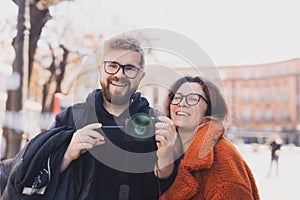Closeup shot of young couple take selfie outdoor. Young man taking photo with his girlfriend. Happpy smiling couple