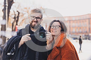 Closeup shot of young couple take selfie outdoor. Young man taking photo with his girlfriend. Happpy smiling couple