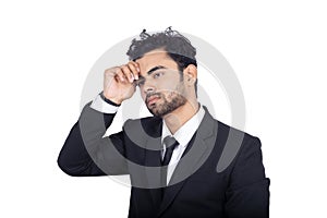 Closeup shot of a young Indian businessman thinking serious isolated white background