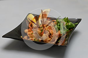 Closeup of shrimp dish on a black plate