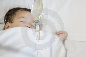 Closeup sick child sleep on hospital bed textured background with copy space