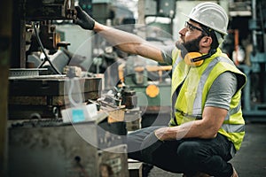 Closeup side view of early 40`s male employee at a factory