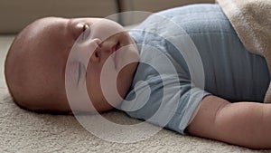 Closeup Side View Funny Cute Kid 2 Month Newborn Boy Falling Asleep After Bath Shower On White Soft Bed. Baby Child