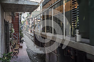 Train goes through a tiny street in Ha Noi, Viet Nam