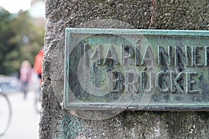 Closeup of a sign on a stone saying Marianne Brucke