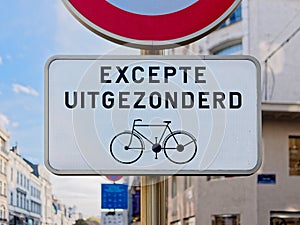 Closeup Signboard information bike in Bruxelles Belgium excepte uitgezonderd = except excepted