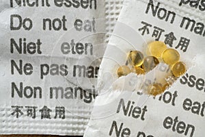 closeup of silica gel packages with cautions