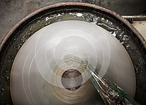 Closeup of Silica Sanding Table Spinning and water drooping photo