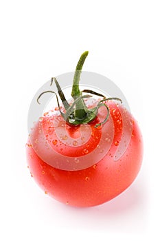 Closeup of single red circular tomato with a green stem